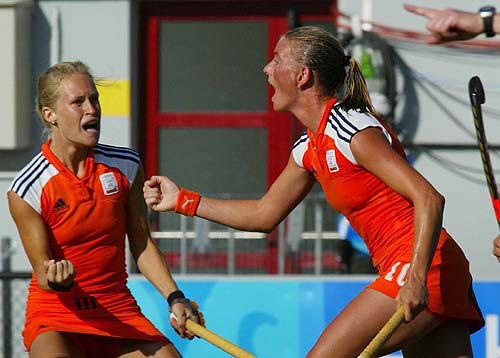 Netherlands' Mijntje Donners, right, celebrates her goal against South Africa with her teammate Minke Booij, during their Pool B preliminary hockey match at the Helliniko hockey center in Athens, Greece, Saturday, Aug. 14, 2004. The Netherlands won 6-2. AP/PTI