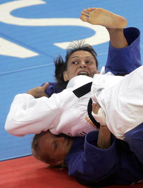 Greece's Maria Karagiannopoulou (top) battles with Poland's Anna Zemla-Krajewska (bottom) to win in their judo women's extra lightweight (under 48kg) event at the Ano Liossia Olympic Hall in the Athens 2004 Olympic Games August 14, 2004. REUTERS/Ruben Sprich