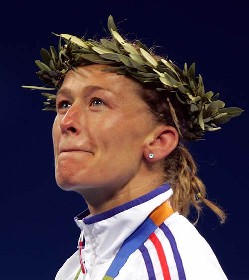 Frederic Jossinet of France listens to the national anthem during the award ceremony of the women 48 kg judo final event at the Athens 2004 Olympic Games, August 14, 2004. Ryoko Tani of Japan defeated Jossinet to capture the gold medal while Jossinet took the silver. REUTERS/Charles Platiau