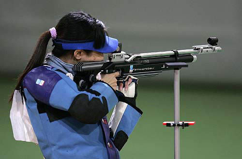 China's Li Du takes aim during the women's 10m air rifle finals Saturday, August 14, 2004, in Athens. Du won the gold; Lioubov Galkina of Russia won the silver; and Katerina Kurkova of the Czech Republic took the bronze. AP/PTI