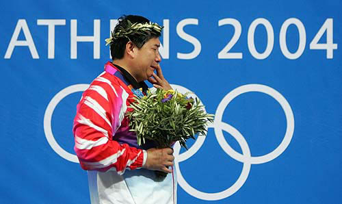 Chinese Olympic marksman Wang Yifu cries during the medal ceremony for the Men's 10 meter air pistol in Athens, August 14, 2004. Wang took gold with a score of 690. REUTERS/Guang Niu