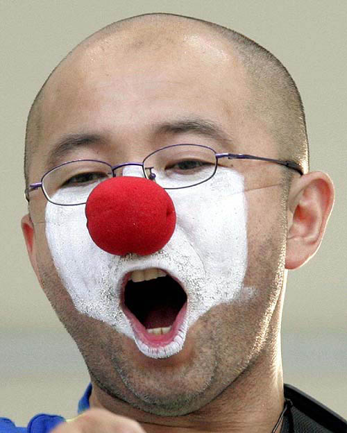 A Japanese fan screams as his team enters the field prior to the start of the group B soccer match between Italy and Japan at the Olympic Games in Volos