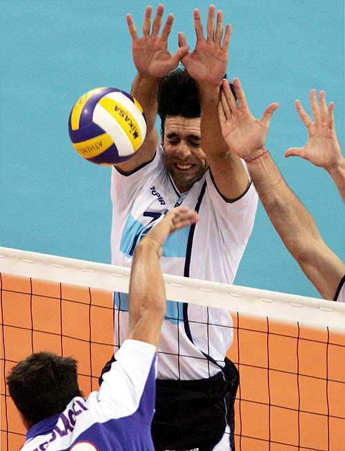 Argentina's Gaston Giani blocks France's Sebastien Frangolacci during their preliminary pool A volleyball match at the Olympic Games on Sunday