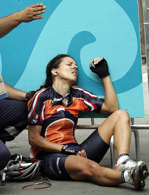 Dutch defending Olympic champion Leontien Zijlaard-Van Moorsel lies against a panel on the side of the road after falling during the women's road race of the 2004 Olympic Games in Athens, Sunday, Aug. 15, 2004. AP/PTI 