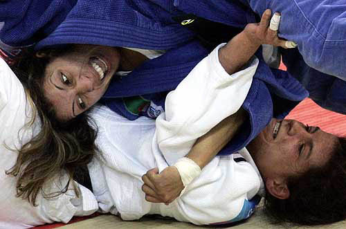 Algeria's Salima Souakri (L) holds Germany's Raffaella Imbriani (R) during their judo women's half-lightweight (under 52kg) match in the Athens 2004 Olympic Games August 15, 2004. Souakri beat Imbriani. 