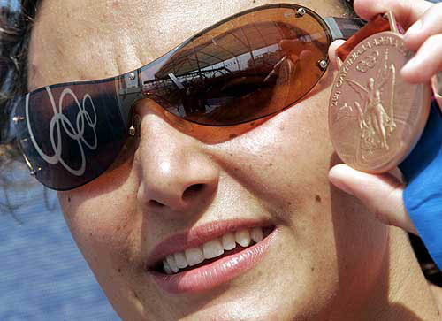 Argentina's swimmer Georgina Bardach poses with her bronze medal at the Olympic Village in Athens, August 15, 2004. Bardach won the bronze medal on August 14 in the women's 400 metres individual medley final, with a time of four minutes 37.51 seconds. REUTERS/Marcos Brindicci
