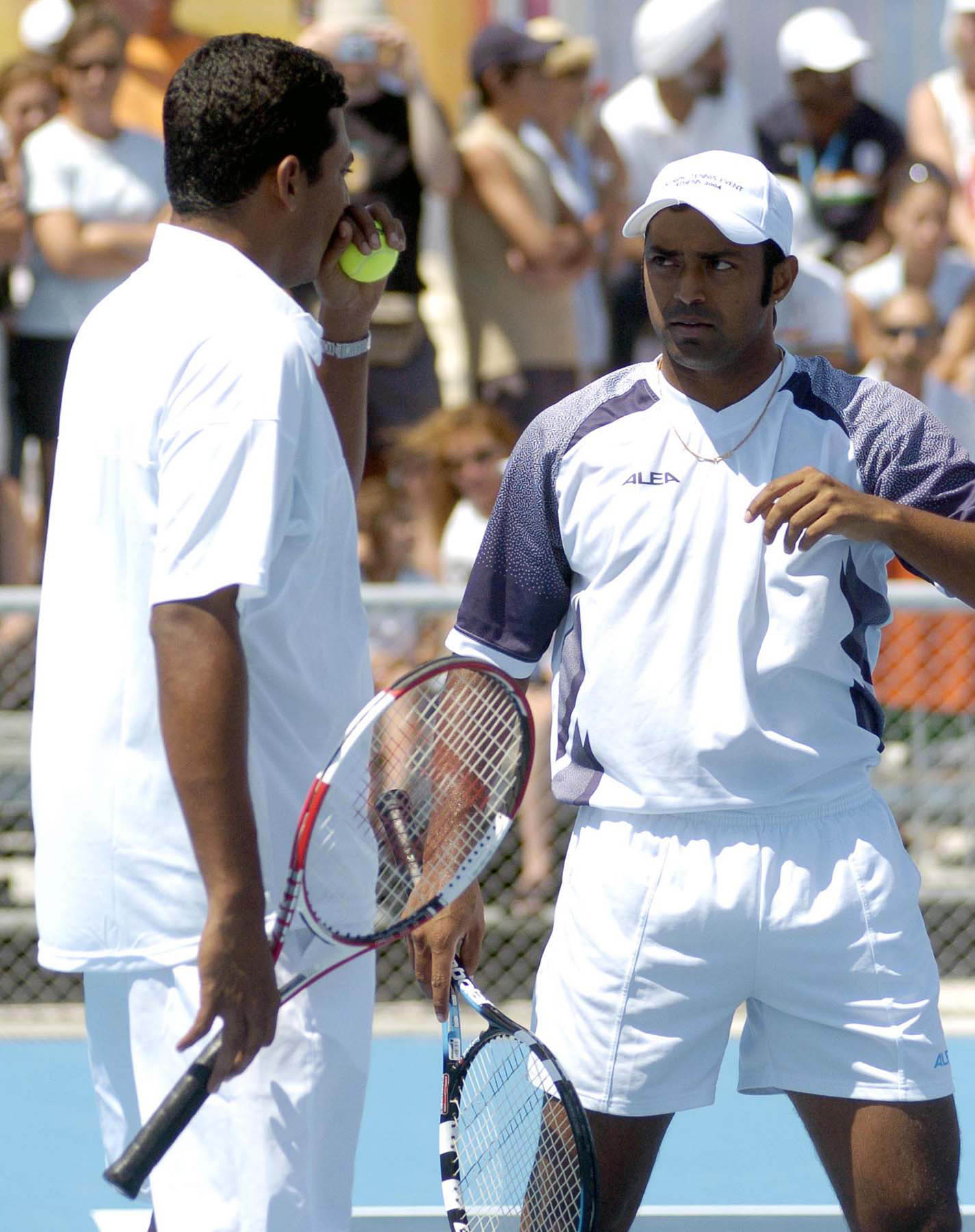 Indian Olympic Tennis doubles team Mahesh Bhuparti, left, and Leander Paes, converse during their match against the U.S. team of Mardy Fish and Andy Roddick during the 2004 OlympicGames tennis competition in Athens Monday Aug. 16, 2004. Bhuparti and Paes won the match. AP/PTI photo