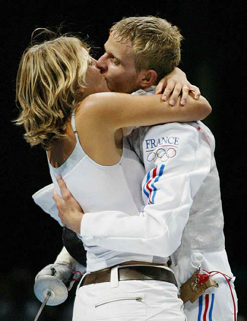 France's Brice Guyart is kissed by an unidentified woman as wins the gold after defeating Italy's Salvatore Sanzo in the final match of the Men's Individual Foil competition of the 2004 Olympic Games at the Helliniko Fencing Hall in Athens, Monday, August 16. AP/PTI photo