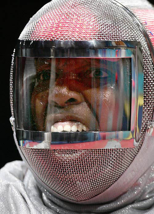 Cuba's Ana Faez Miclin shouts from behind her new transparent mask to celebrate her win in the women's fencing individual sabre competition against South Korea's Lee Shin-mi at the Athens 2004 Olympic Games August 17, 2004.  Reuters photo
