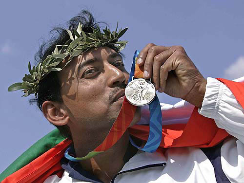 India's Major Rajyavardhan Singh Rathore kisses his silver medal after the men's double trap finals on Tuesday, August 17 in Athens during the 2004 Olympic Games.  AP/PTI photo