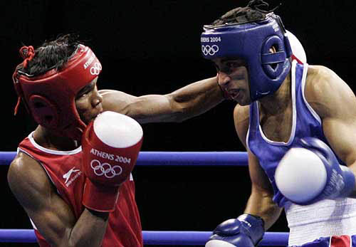 India's Diwakar Prasad, left, throws a punch on Morocco's Hamid Ait Bighrade during the bantamweight boxing preliminaries in the 2004 Athens Summer Olympic Games at the Peristeri boxing hall in Athens on Tuesday, August 17. Prasad won the matcfh. — AP/PTI photo