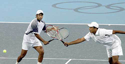 Indian doubles partners Leander Paes, left, and Mahesh Bhupathi return the ball to their Swiss opposition, Roger Federer and Yves Allegro, during the second round men's doubles Olympic 2004 match on number 1 court at the tennis complex in Athens on Tuesday August 17. — AP/PTI photo