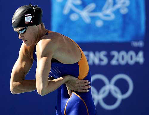 The Netherlands' Inge de Bruijn stretches before swimming in her 100-metre freestyle heat at the Athens 2004 Olympic Games, August 18. De Bruijn had the fastest qualifying time.  Reuters photo
