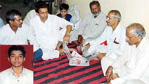 Grieving relatives of Vijay Kumar (inset), who was allegedly assaulted by a Head Constable in Phagwara on Tuesday.