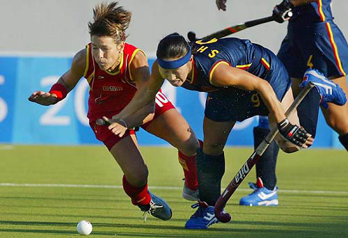 China's Li Shuang, right, and Spain's Lucia Lopez collide as they fight for the ball during their 2004 Olympic Games field hockey match in Athens, Greece, Wednsday, August 18. China defeat Spain 3-0.  AP/PTI photo
