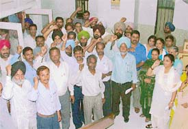 Telecom employees raise slogans in support of their demands in Ludhiana