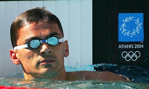 Alexander Popov from Russia looks at the scoreboard after his heat in the men's 50 metres freestyle at the Athens 2004 Olympic Games on August 19.  Reuters