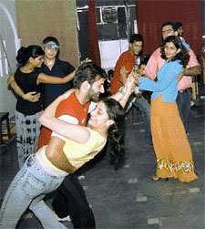 Couples practice Salsa dance steps at Foot Loose, a dance institute