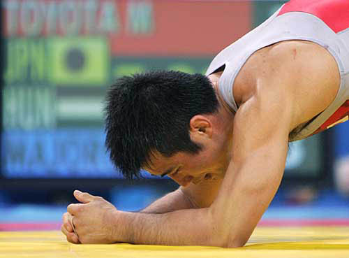 Japan's Masatoshi Toyota rests on his elbows during his bout with Hungary's Istvan Majoros in their men's Greco-Roman wrestling (under 55kg) competition at the Athens 2004 Olympic Games on August 24. Majoros defeated Toyota 5-3 on points.
