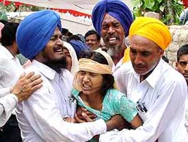 The sister of Army jawan Kuldip Singh, who was killed in Jammu, cries over his death, in Bathinda on Tuesday.
