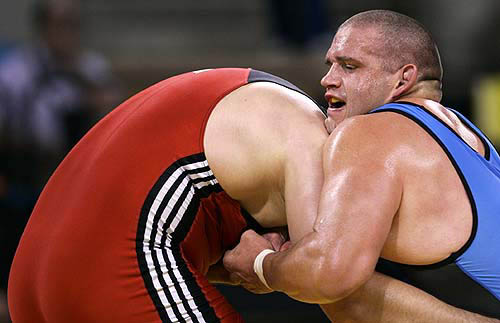 Rulon Gardner (right) of the US grapples with Kazakhstan's Georgiy Tsurtsumia (left) during their men's Greco-Roman (under 120 kg) heavyweight wrestling bout at the Athens 2004 Olympics on August 25. Gardner lost his Olympic title after he was defeated in the semi-final stage of the 120 kg Greco-Roman wrestling event by Tsurtsumia.
