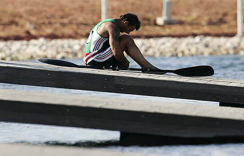 Exhausted, Hungarian kayaker Istvan Bee sits on the dock after he and teammate Zoltan Benko qualified for the finals in the men's K2 1000-metre during competition at the Athens 2004 Olympics on August 25. The Hungarians placed third.