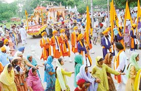 Devotees hold a procession in connection with Guru Granth Sahib’s quadricentennial celebrations on September 1
