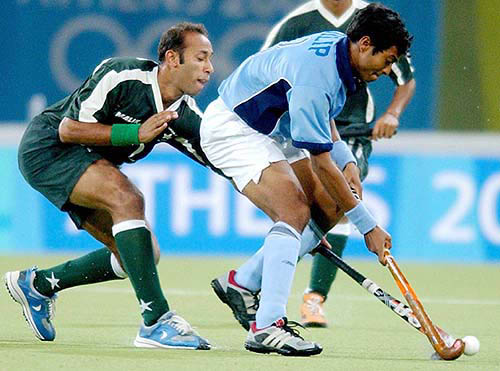 Pakistan's Ali Ghazanfar fights for the ball with India's Dilip Tirkey during their 2004 Olympic Games field hockey semi-final match in Athens, Greece on August 25.