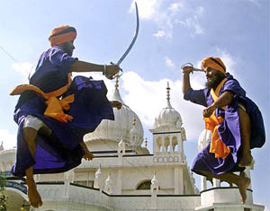 Nihangs practice Gatka, a traditional martial art, before a procession to mark the 400th anniversary of the installation of Guru Granth Sahib