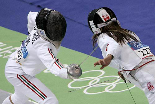Zsuzsanna Voros of Hungary (left) lunges towards Liudmila Sirotkina of Kyrgyzstan during the fencing discipline of the women's modern pentathlon competition at the Athens 2004 Olympic Games on August 27.