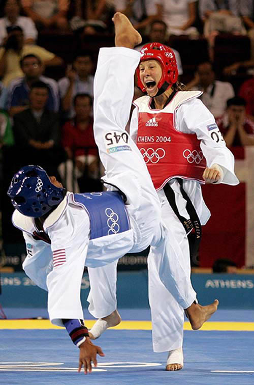 Nia Abdallah of the USA (left) misses a kick on Cristiana Corsi of Italy during the quarter-finals of the under 57kg taekwondo at the Athens 2004 Olympic Games on August 27.