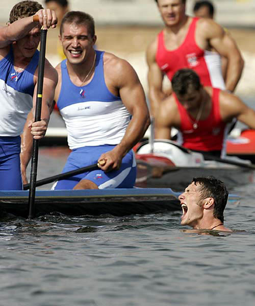 Germany's Tomasz Wylenzek (in water) celebrates his gold medal win as Russia's Alexander Kostoglod and Alexander Kovalev laugh after the men's C2 1000 metres finals at the Athens 2004 Olympic Games on August 27. Germany won gold in a time of three minutes 41.802 seconds.