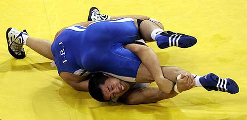 Iran's Majid Khodaei grapples with Japan's Hidekazu Yokoyama (bottom) in the men's wrestling freestyle 84kg bout at the Athens 2004 Olympic Games on August 27. Khodaei defeated Yokoyama.