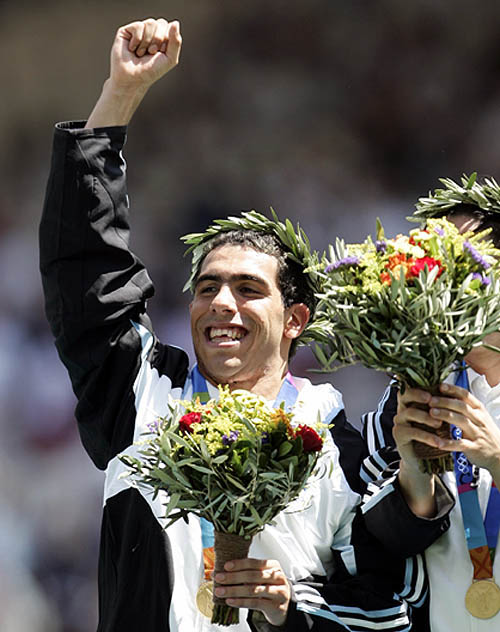 Argentina's Carlos Tevez, who scored the only goal in the soccer final, celebrates after the medal ceremony at the Athens 2004 Olympic Games on August 28