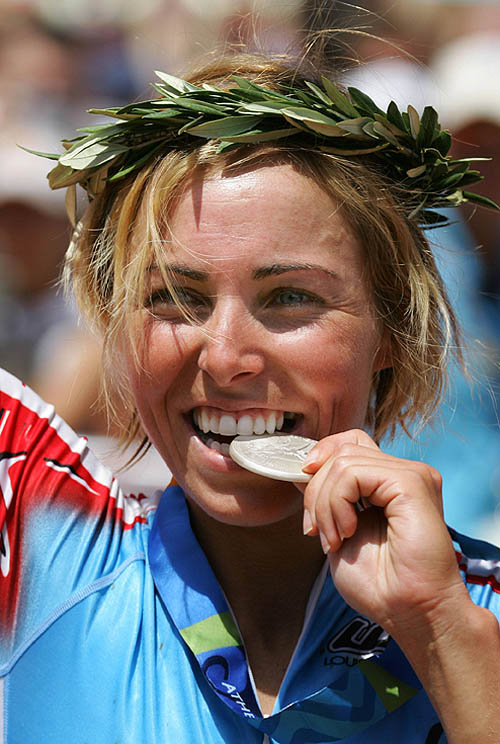 Canada's Marie-Helene Premont bites her Olympic women's mountain bike silver medal on the podium at the Athens 2004 Olympic Games on August 27