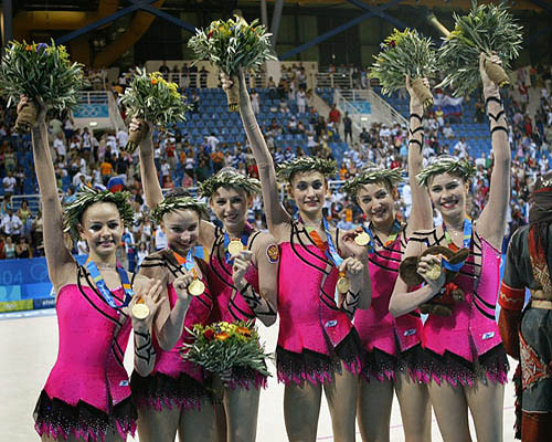 Russian gymnasts celebrate after the medal ceremony for the all-around rhythmic gymnastic at the Athens 2004 Olympic Games on August 28