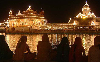 Devotees sit alongside the sarovar as the Golden Temple glitters ahead of the quadricentennial celebrations