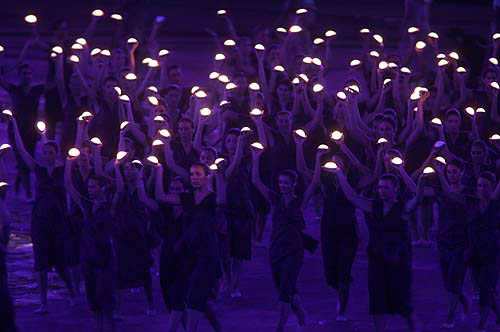 Performers carrying lights take part in the closing ceremony of the Athens 2004 Olympic Games August 29, 2004. The next summer Olympic Games will be held in Beijing in 2008. REUTERS/Arko Datta