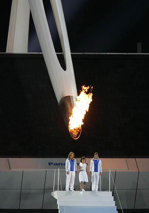 A child walks with a lantern lit from the Olympic flame during the closing ceremony of the Athens 2004 Olympic Games August 29, 2004. The next summer Olympic Games will be held in Beijing in 2008. REUTERS/Mike Blake