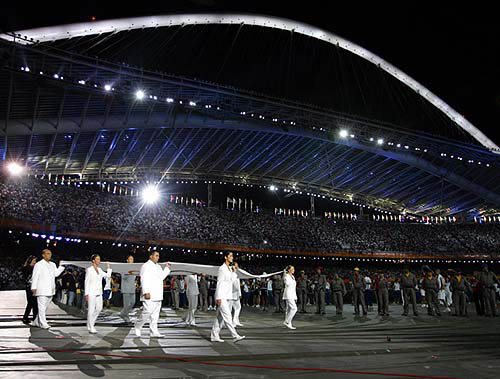 The Olympic flag is carried during the closing ceremony of the Athens 2004 Olympic Games August 29, 2004. The next summer Olympic Games will be held in Beijing in 2008. REUTERS/Eric Gaillard