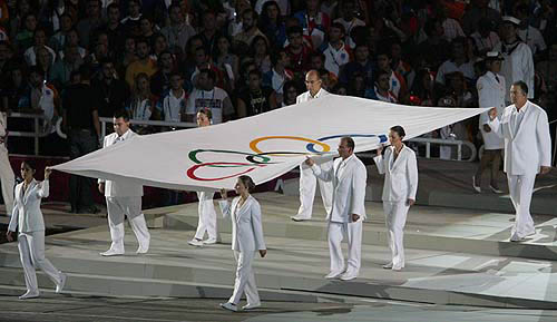Volunteers carry the Olympic flag during the closing ceremony of the Athens 2004 Olympic Games August 29, 2004. The next summer Olympic Games will be held in Beijing in 2008. REUTERS/Lucy Nicholson