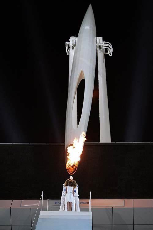 A lantern is lit from the Olympic flame during the closing ceremony of the Athens 2004 Olympic Games August 29, 2004. The next summer Olympic Games will be held in Beijing in 2008. REUTERS/Adrees Latif