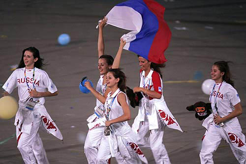 Athletes from Russia wave their national flag during the closing ceremony of the Athens 2004 Olympic Games August 29, 2004. The next summer Olympic Games will be held in Beijing in 2008. REUTERS/Mike Blake