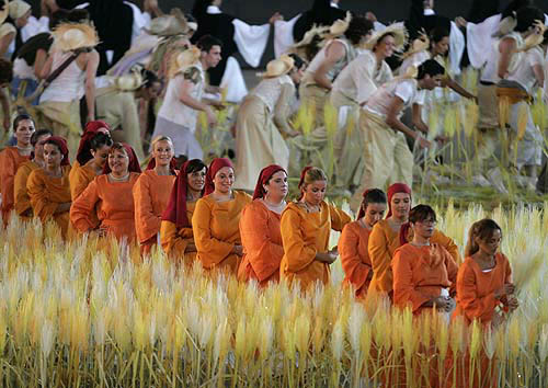 Volunteers take part in the closing ceremony of the Athens 2004 Olympic Games August 29, 2004. The next Olympic Games will be held in Beijing in 2008. REUTERS/Mike Blake