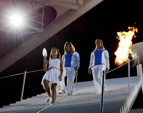 A child walks with a lantern lit from the Olympic flame during the closing ceremony of the Athens 2004 Olympic Games August 29, 2004. The next summer Olympic Games will be held in Beijing in 2008. REUTERS/Kimimasa Mayama