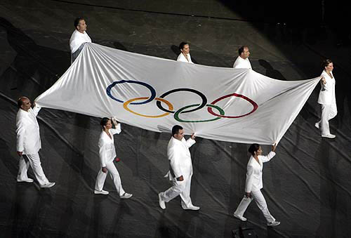 The Olympic flag is carried during the closing ceremony of the Athens 2004 Olympic Games August 29, 2004. The next summer Olympic Games will be held in Beijing in 2008. REUTERS/Reinhard Krause