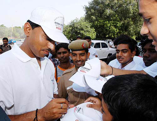 The only Indian medallist from Athens, Major Rajyavardhan Singh Rathore, signs autograph books for fans during the national sports day celebrations in Delhi on August 29.