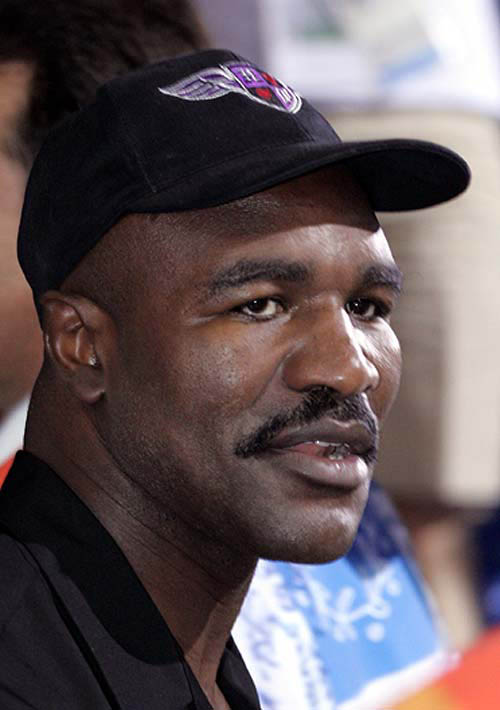 Evander Holyfield, three times world heavyweight champion, watches a bout at the final day of the Athens 2004 Olympic Games on August 29.