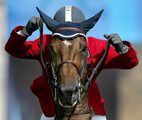 Who Knows Lilly, ridden by Argentina's Federico Sztyrle, clears a jump during the first qualifying round of the show jumping competition at the Markopoulo equestrian centre in the Athens 2004 Olympic Games on August 22.