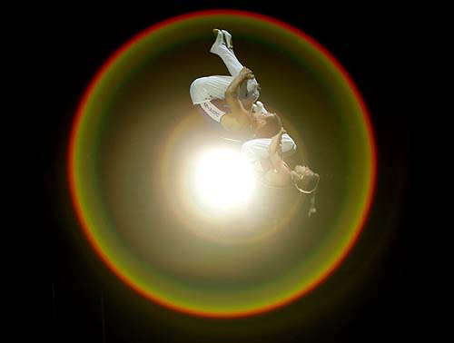 Olympic gold medallist Yuri Nikitin from Ukraine (left) and bronze medallist Henrik Stehlik of Germany perform on the trampoline during an artistic gymnastics exhibition at the Athens 2004 Olympic Games on August 24.